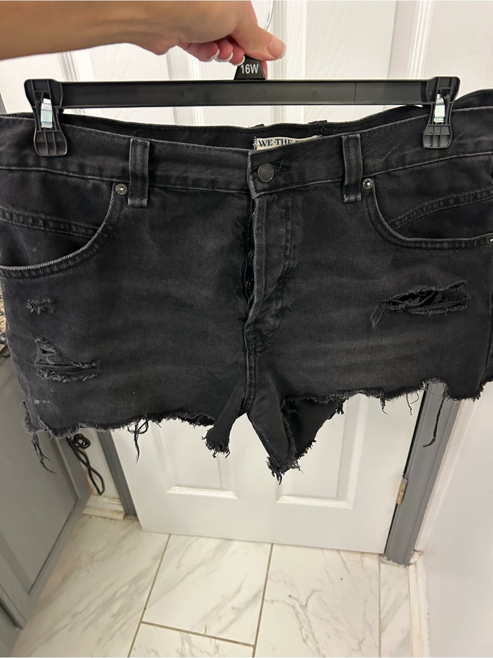 NWOT FREE PEOPLE black destroyed denim shorts.